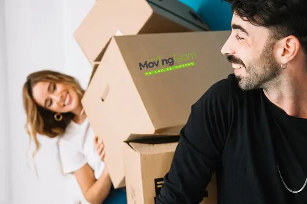 A person on the phone confirming moving day details with their Auckland movers, using a checklist to ensure everything is correct.
