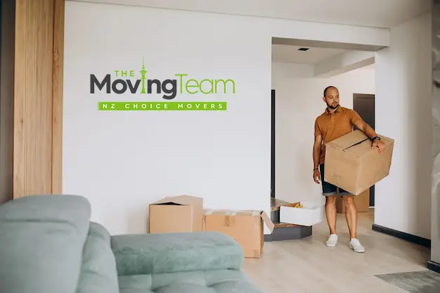 Person reviewing factors affecting apartment moving cost in Auckland, considering high-rise and access challenges