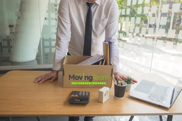 Business manager carefully budgeting for office move cost in Auckland, reviewing a detailed quote.