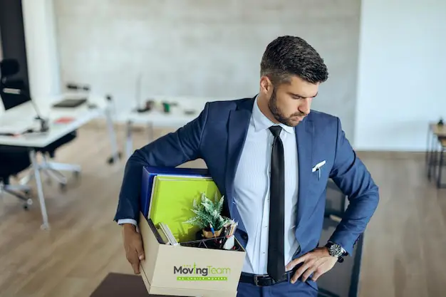 A move coordinator from our team communicating the office relocation plan to an engaged group of employees in a meeting.