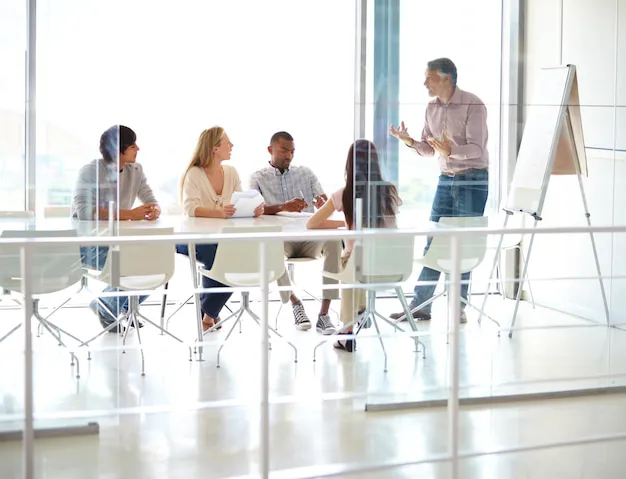 A project team in a meeting, creating a strategic office move project plan for a seamless Auckland relocation.