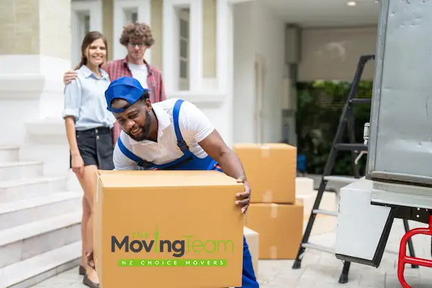 Professional office movers carefully transporting office furniture and equipment for a business relocation in West Auckland.