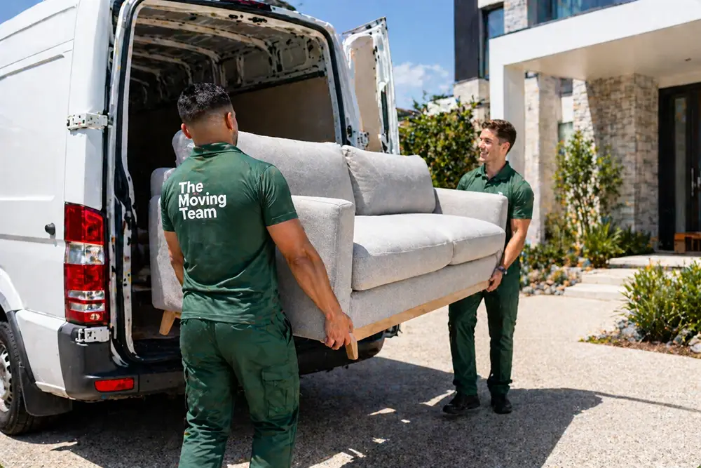 abor Only Movers Auckland, Professional labor only movers Auckland team safely loading a heavy couch into a rental truck.