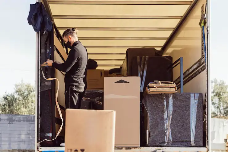 Professional movers using the tier stacking method for loading a rental truck in Auckland.