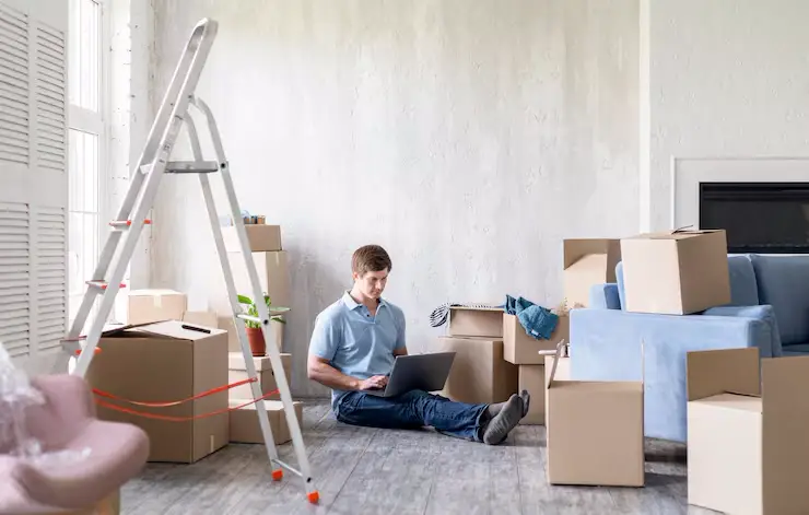 Auckland CBD movers carefully loading furniture into a high-rise building service elevator using protective padding.